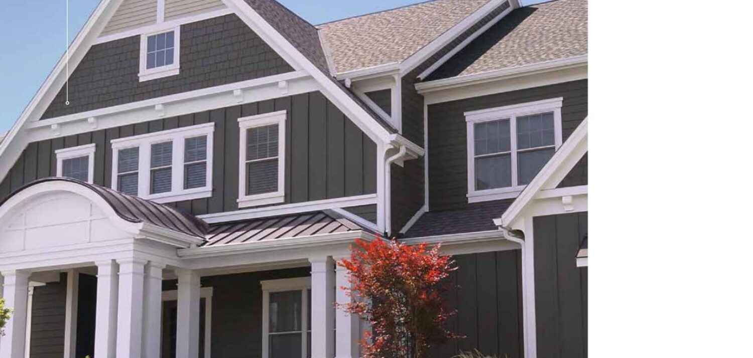 Complete exterior in James Hardie fiber cement siding — board-and-batten, shingle, and trim in dark gray with white accents on a craftsman-style home