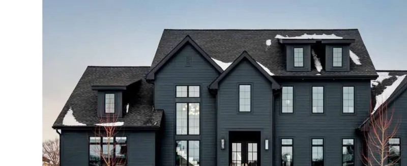 Dark gray modern home in James Hardie plank Shou Sugi Ban color with black window frames